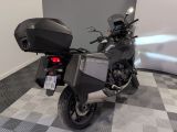 a motorcycle that is parked in a room with a checkered floor