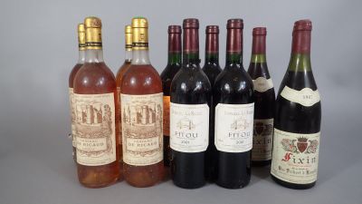 several bottles of wine are lined up on a table