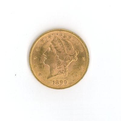 a gold coin on a white surface with a white background