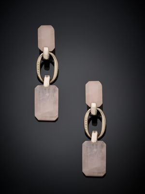 a pair of earrings with pink stone and silver metal