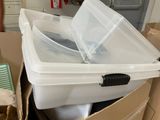 a white box with a plastic lid sitting on top of a cardboard box