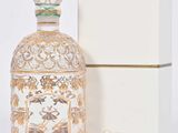 l'image d'un flacon de parfum posé à côté d'une boîte