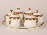 white and gold sugar and creamer set on a tray