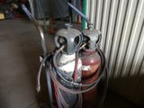 a propanene gas tank with a hose attached to it