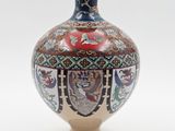 a vase that is sitting on a white surface
