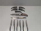 a lot of knives and knives that are on the table