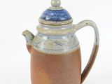 a brown and blue tea pot with a lid