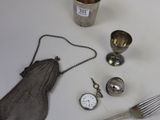 a table with silverware and a clock on it