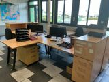 a desk with two computers and a printer on it