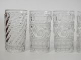 four glasses sitting next to each other on a table