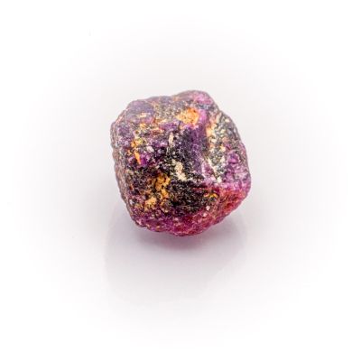 pink and purple rock on a white surface with a white background