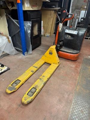 a fork and a fork lift in a warehouse