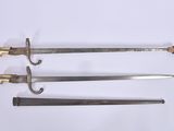 three different types of swords are displayed on a white surface