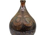 a brown vase that is sitting on a white surface