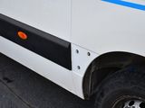 a white van with a blue stripe parked on the side of the road