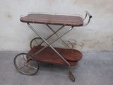 a small wooden cart with a metal handle on it