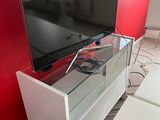 a flat screen tv sitting on a stand in a living room
