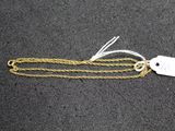 a gold chain with a tag attached to it