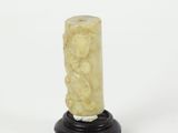 an image of a carved candle on a black stand on a white background