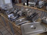many pans and pans on a table in a kitchen