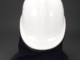 a white hard hat sitting on top of a black hat