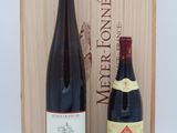 two bottles of wine in front of a wooden box on a table