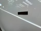 a sticker on the hood of a white car