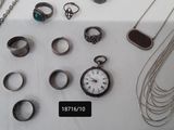 many different types of jewelry displayed on a table