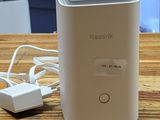 an image of a small white device sitting on top of a wooden table