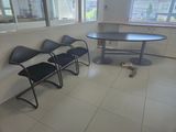 three chairs and a table in the corner of a room