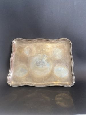 a silver tray with circles on it sitting on a table