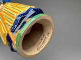 a vase that has a blue and yellow design on it