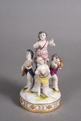 a figurine of a group of children on a pedestal