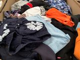 a cardboard box filled with clothes and other items