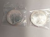 two silver coins in a plastic bag on a table