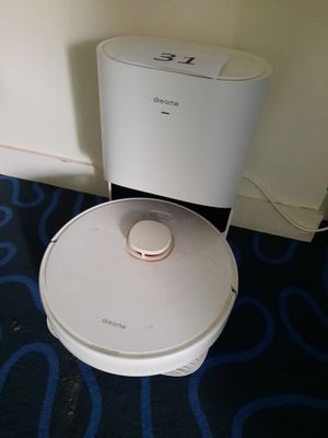 a robot that is sitting on the floor next to a toilet
