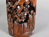 a wooden cup that has a picture of a dragon on it