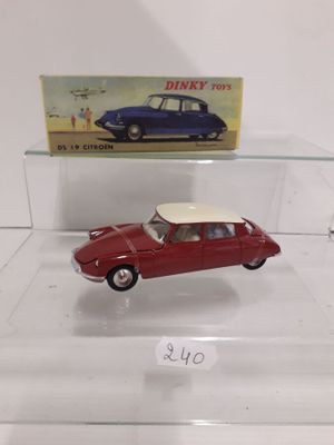 a small red car with a white top in a display case