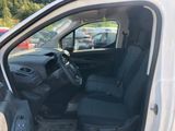 the interior of a white van with the door open and the driver ' s seat up