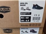 boxes of shoes are stacked on top of each other on a shelf
