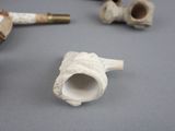 three pipe holders that are sitting on a table