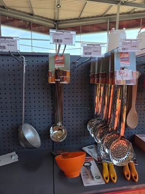 many utensils hanging on the wall in the store