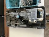 two electric tools sitting on top of each other