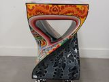 an image of a colorful chair in the corner of a room