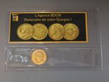two gold coins are in a clear plastic holder on a table