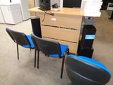 trois chaises devant un bureau sur lequel est posé un ordinateur