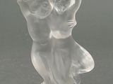une figurine en verre représentant deux personnes se tenant la main