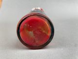 an image of a red glass bottle sitting on top of a table