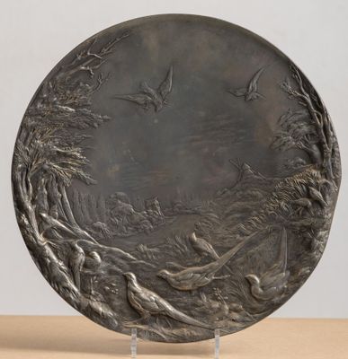 a close up of a metal plate on a wooden table