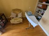 a ironing board and a chair in a room